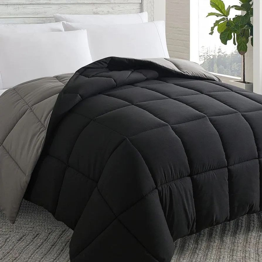 Sleek black quilted duvet paired with white pillows on a contemporary bed, offering a cozy and modern bedroom vibe. Shop now for this duvet sale.