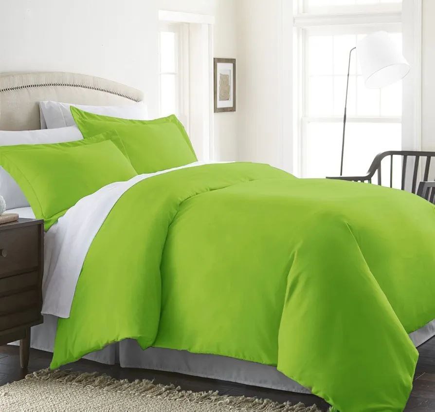 Modern bedroom featuring a bright green duvet with matching pillows, creating a refreshing and vibrant look. A bold choice for adding color with a duvet.