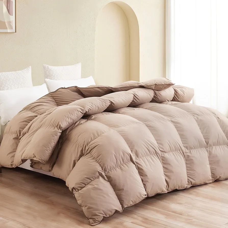 Warm and cozy bedroom with a beige puffy duvet and crisp white pillows, offering a soft and comfortable atmosphere. A stylish duvet perfect for relaxation.