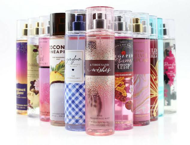 Collection of Bath and Body Works fine fragrance mists in various scents, arranged in a row with colorful packaging designs.