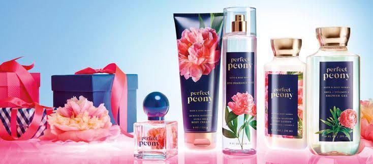 Bath and Body Works Perfect Peony collection featuring body cream, fragrance mist, shower gel, and perfume, arranged with gift boxes and floral decor.