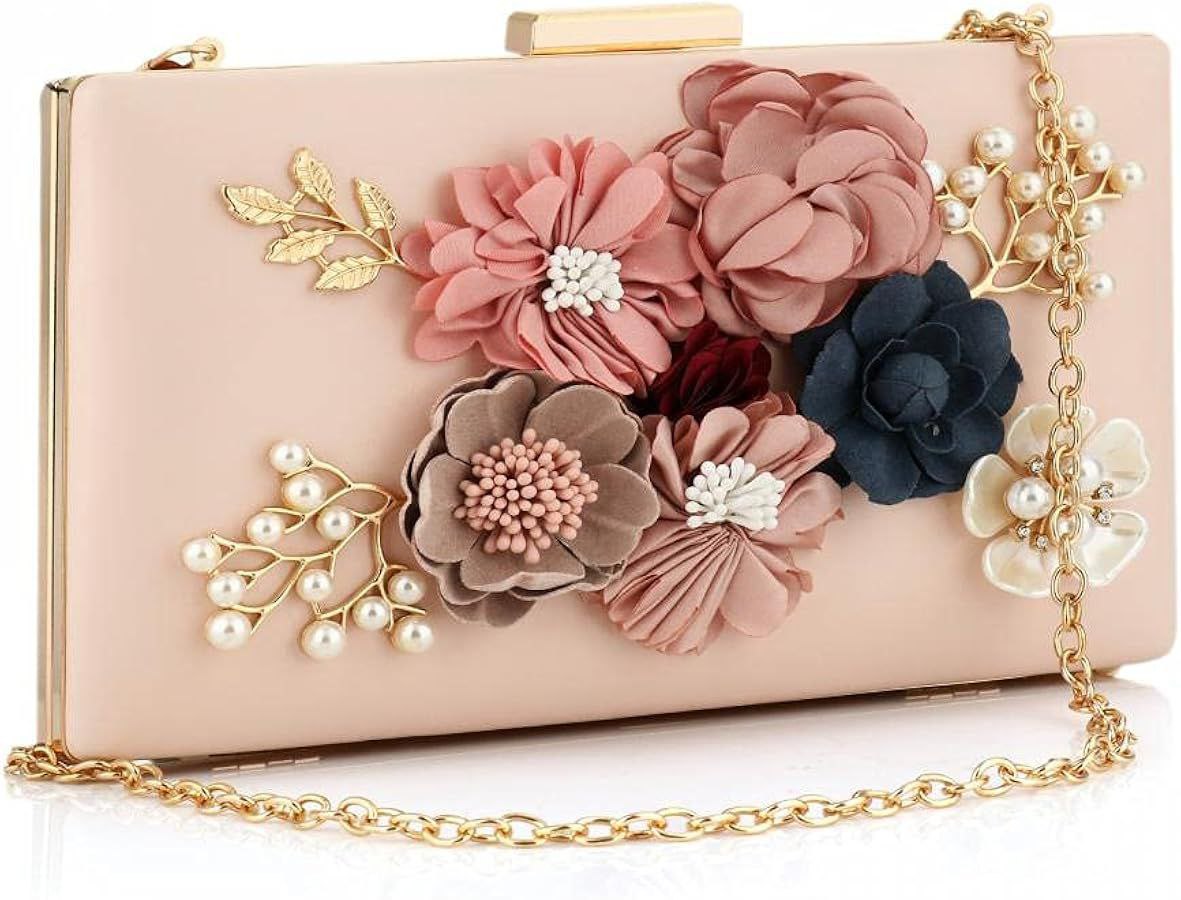 Elegant floral clutch bag with 3D fabric flowers in soft pink, beige, and navy tones, accented by pearl and gold leaf embellishments, complete with a delicate gold chain strap.